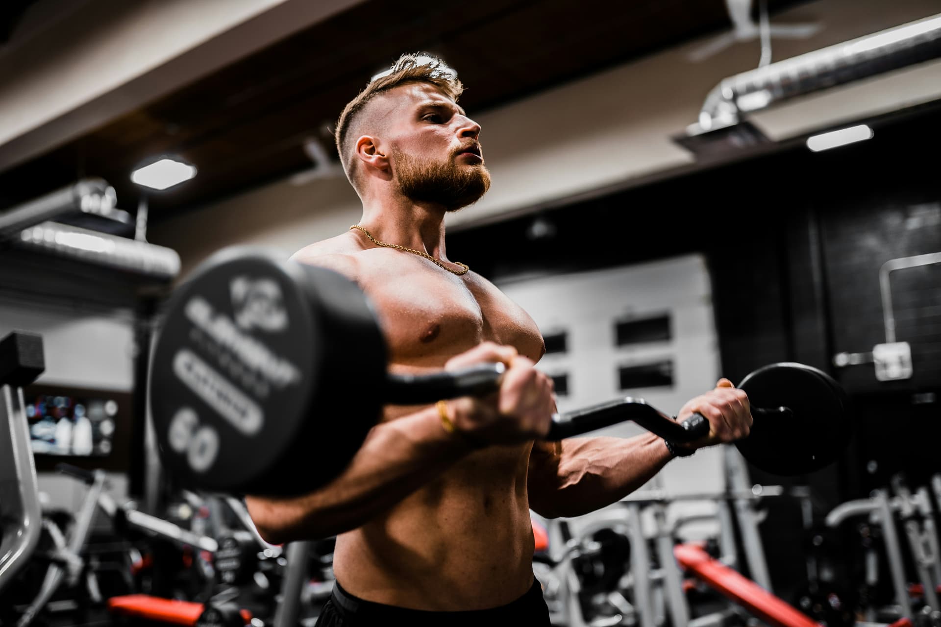 Athlete curling a barbell